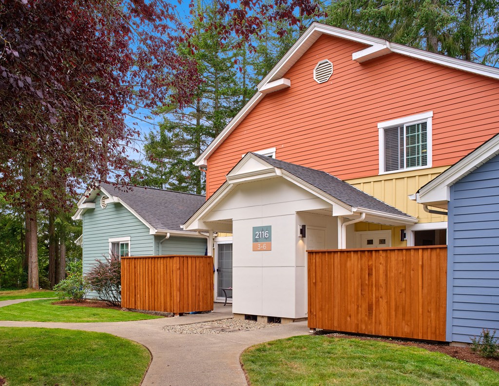 a group of houses with a sidewalk and a fence at Woodcreek, Poulsbo, 98370