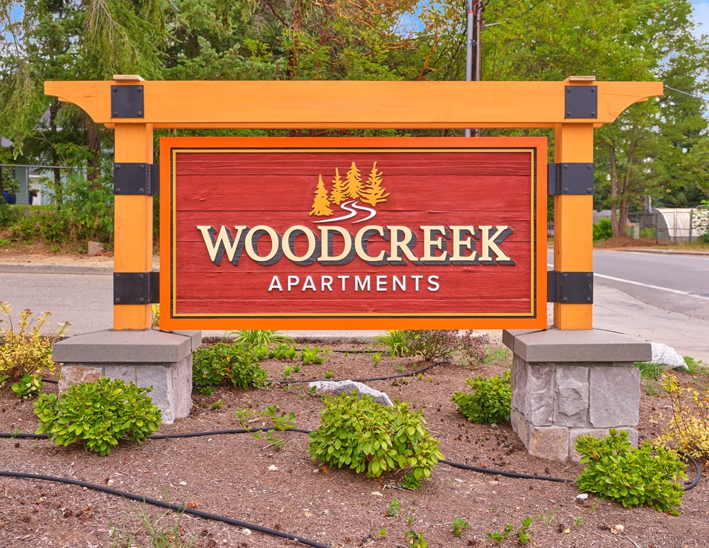 a sign for wood creek apartments on the side of the road at Woodcreek, Poulsbo, WA