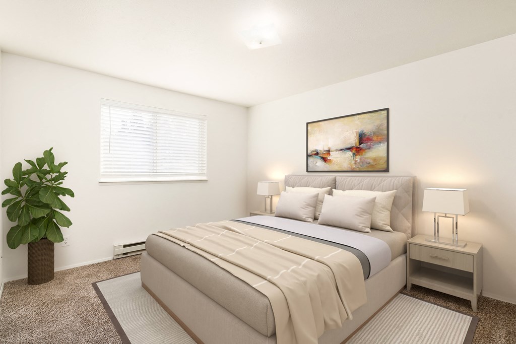 A bedroom with white walls, taupe carpets, and a large window with blinds. Staged with a bed, 2 side tables, a rug, and a plant.at Clearwater, Idaho, 83854