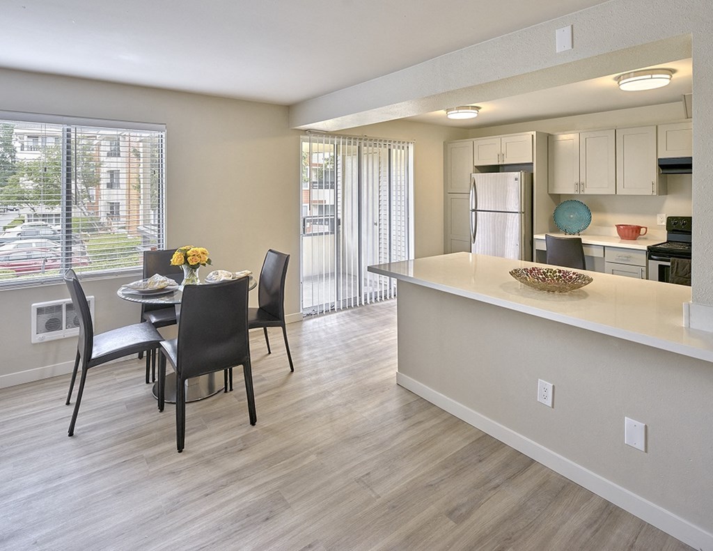 a kitchen and dining area with a large window  at 3030 Lake City, Seattle, 98125