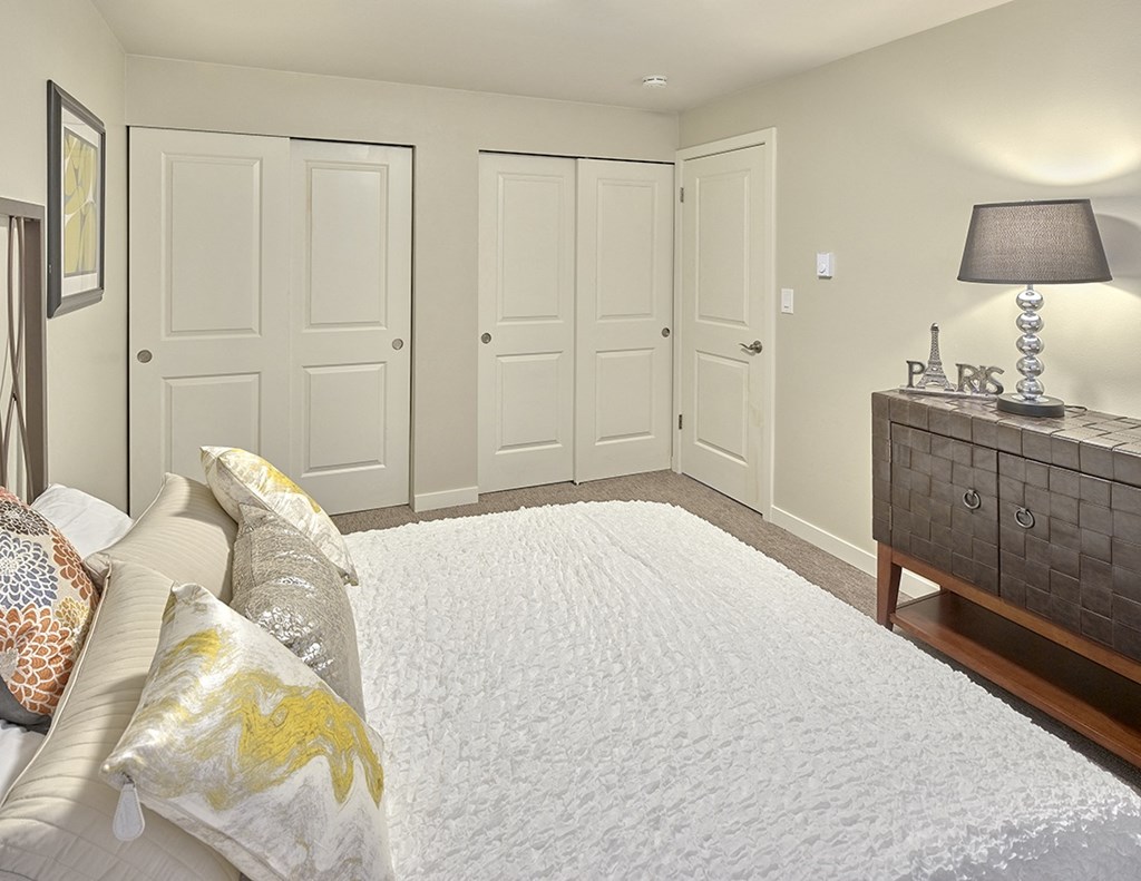 a bedroom with white closets and a white bedspread  at 3030 Lake City, Seattle, Washington