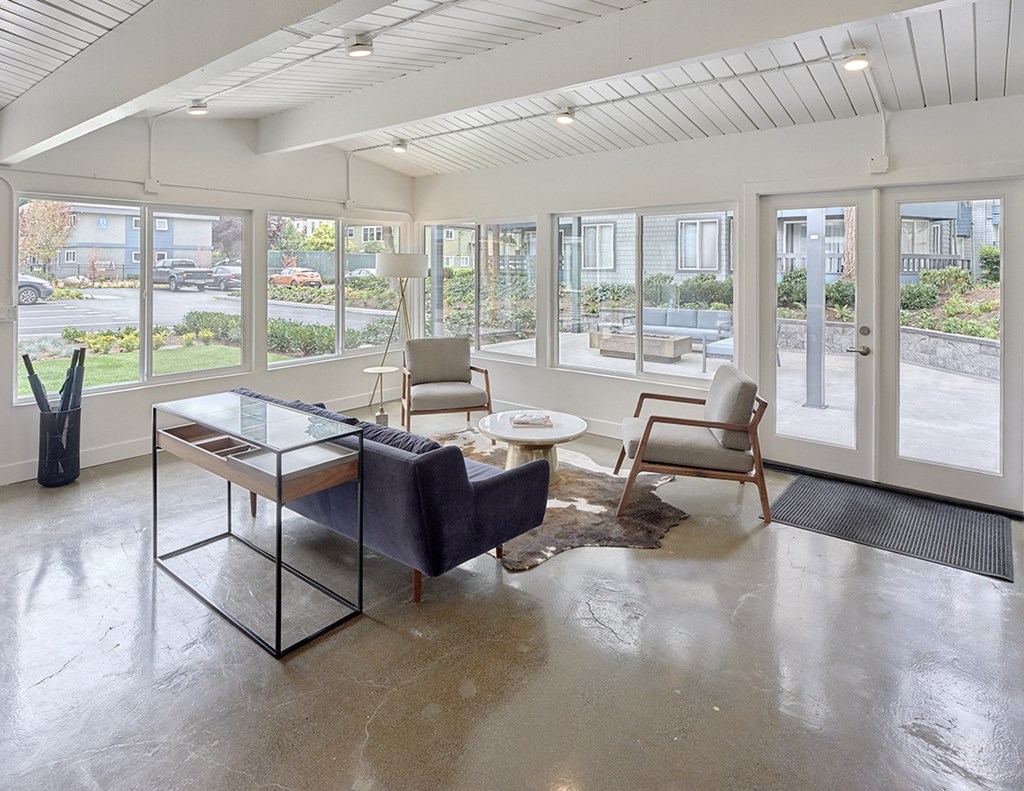 a resident lounge with a large window and a view of an outdoor seating area  at 3030 Lake City, Seattle, WA, 98125