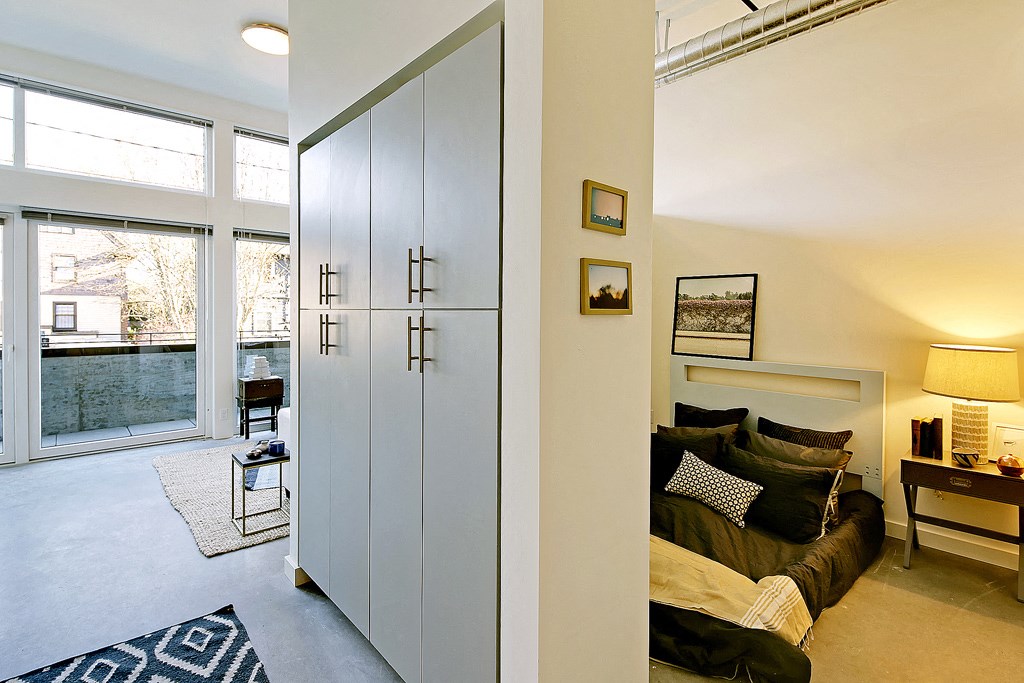 Open one-bedroom layout with storage space and an outdoor patio.at 19th & Mercer, Seattle