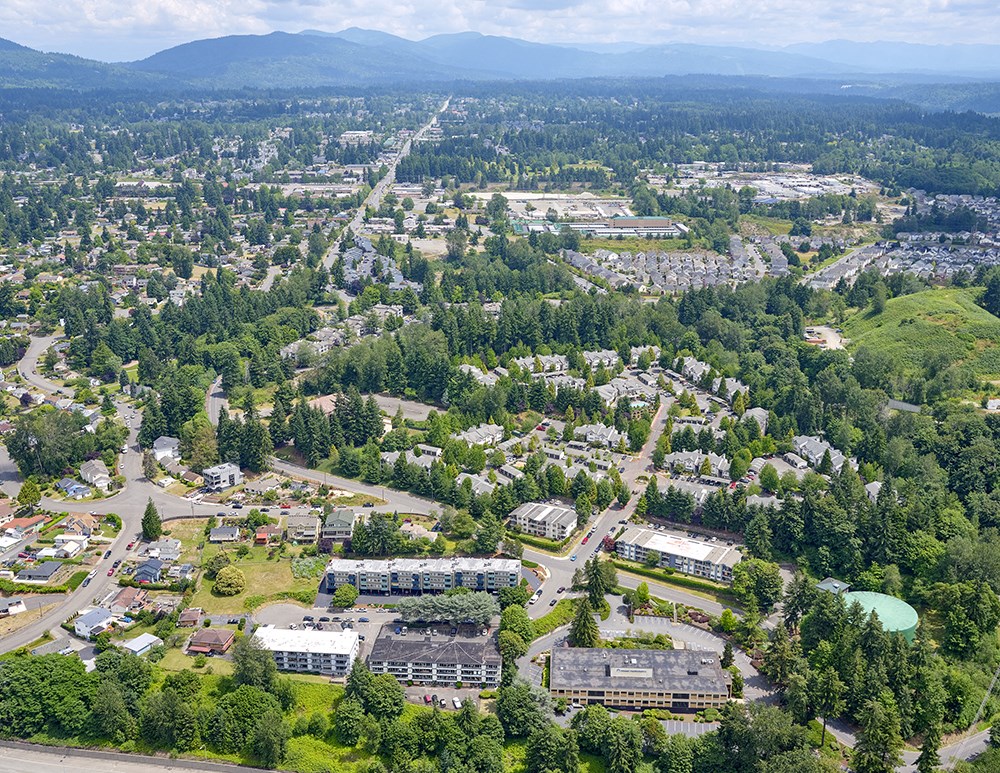 View of Peak 88 from above, surrounded by trees with mountains in the distance.