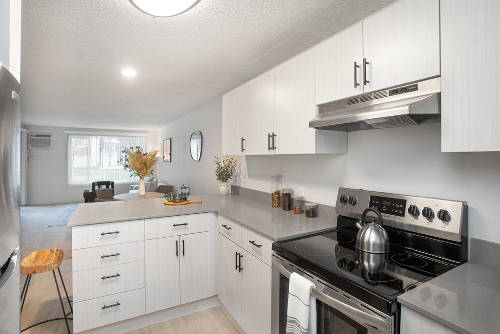 an open kitchen with white cabinets and stainless steel appliances at Brix, Walla Walla, WA, 99362