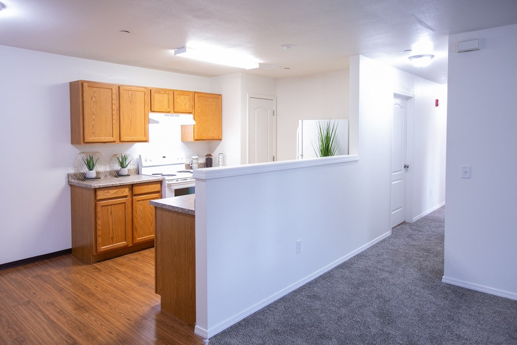 an empty kitchen with wood flooring and a white wall  at Canyon View, Idaho, 83501