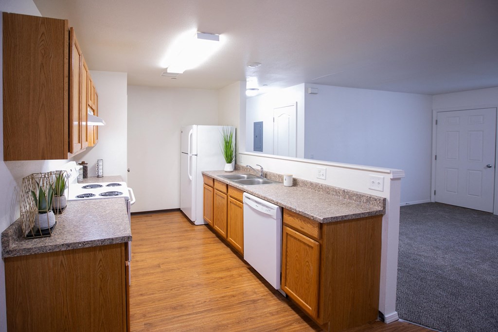 an empty kitchen with wood floors and white appliances at Canyon View, Idaho