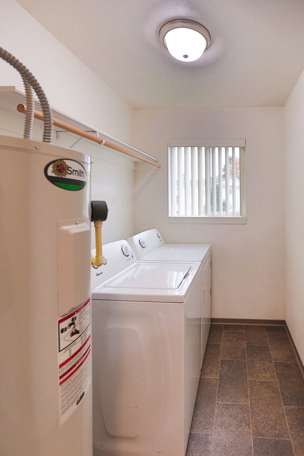 the laundry room has a washer and dryer and a window at Canyon View, Idaho