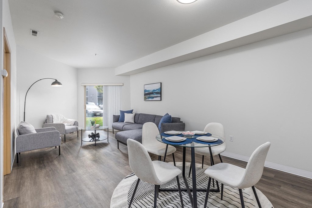 a living room with a couch and a table and chairs  at Shoreline Village, Richland, WA, 99352