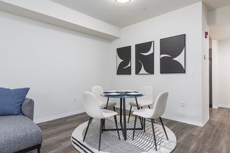 a dining room with a table and chairs and a couch