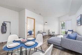 a living room with a table and chairs and a couch