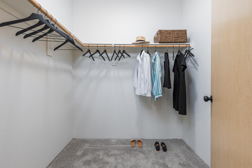a walk in closet with a clothes rack and shoes on the floor  at Shoreline Village, Richland, WA, 99352