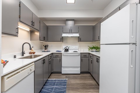 a kitchen with white appliances and gray cabinets  at Shoreline Village, Richland, WA
