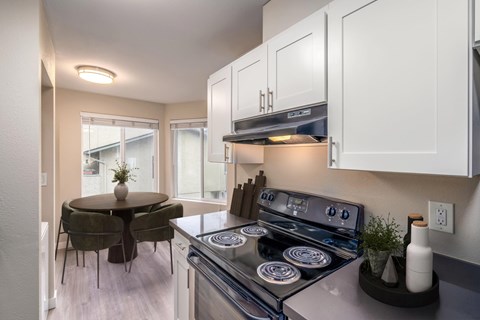 Modern kitchen with full-size appliances and dining area at 3030 Lake City Apartments in Lake City