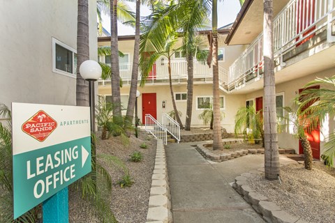 Pacific Sands walkway with Leasing Office sign and tropical landscaping at Pacific Sands, San Diego, CA, 92117