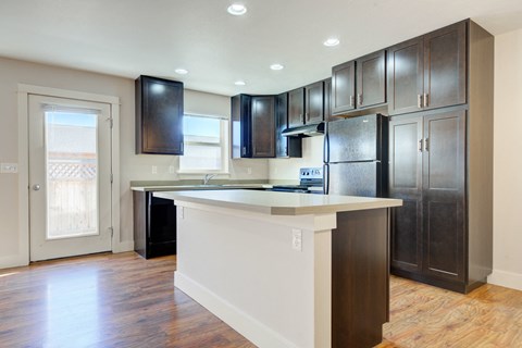 a kitchen with a large island and dark wood cabinets at Copper Pines, Bozeman, MT 