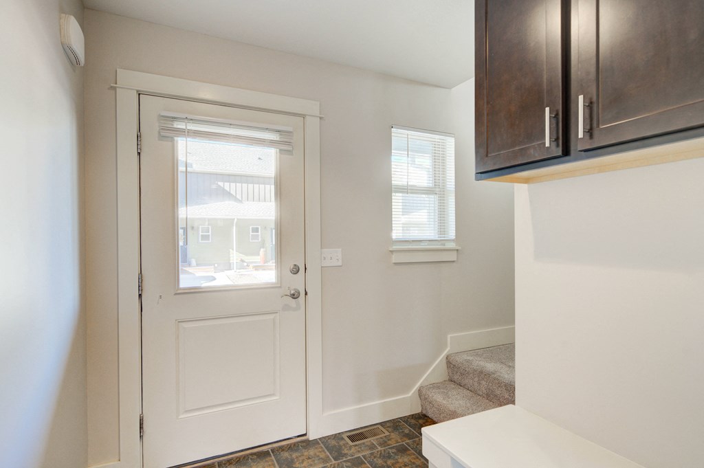 a entryway with a white door and a stairwell with a window at Copper Pines, Bozeman, MT, 59718