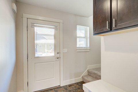 a entryway with a white door and a stairwell with a window at Copper Pines, Bozeman, MT, 59718
