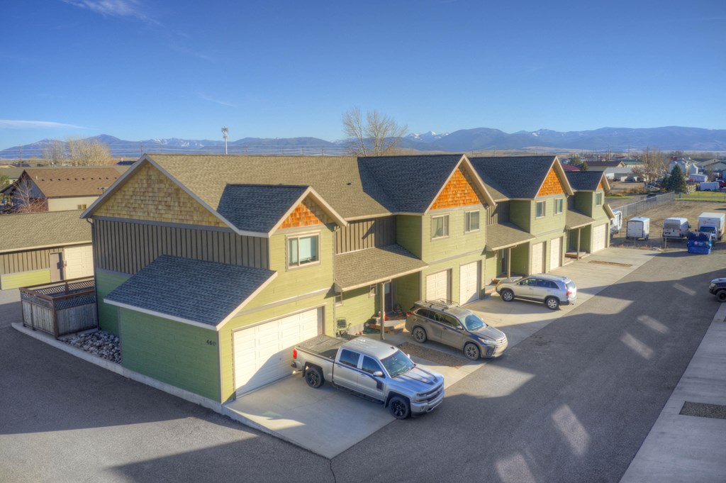 a row of houses with cars parked in front of them at Copper Pines, Montana