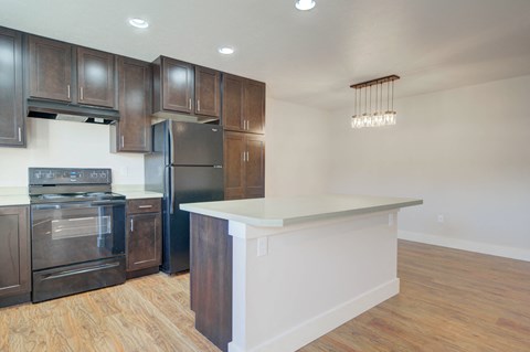 a kitchen with a large island and stainless steel appliances at Copper Pines, Bozeman