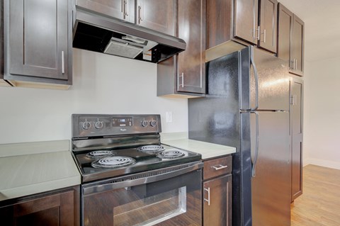 an empty kitchen with stainless steel appliances and wooden cabinets at Copper Pines, Bozeman, MT, 59718