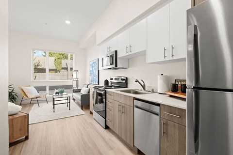 a kitchen with stainless steel appliances and white cabinets