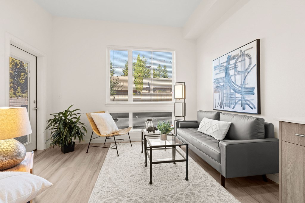 a living room with a couch and a chair and a window couch