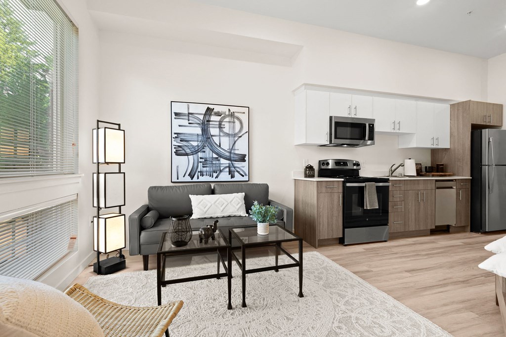 a living room with a couch and a table at The Duo, University Place, WA