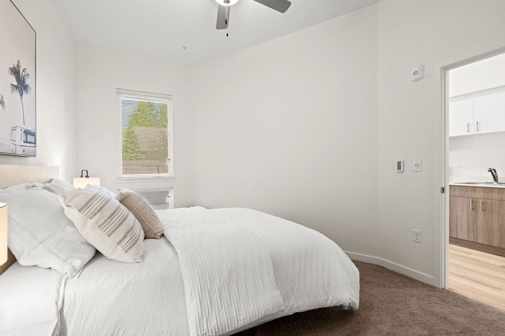 a white bedroom with a bed and a ceiling fan at The Duo, Washington, 98466