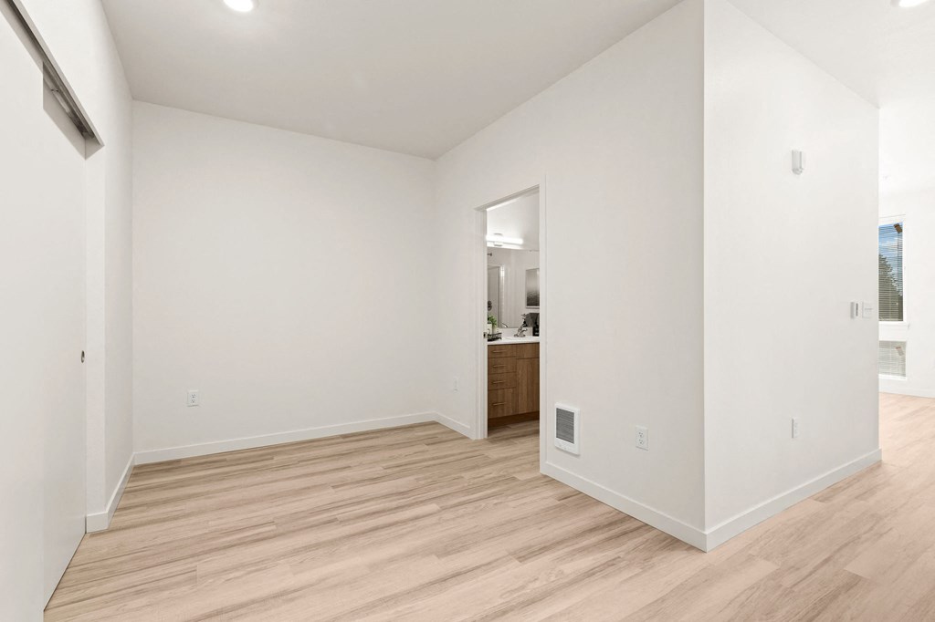 a living room with white walls and wood floors g room with white walls and wood floors at The Duo, University Place Washington