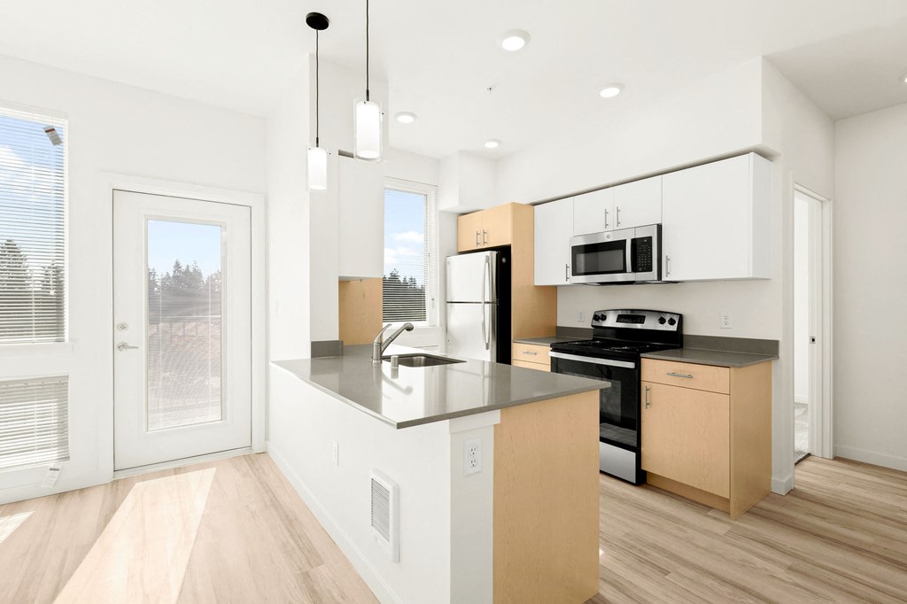a kitchen with a large island and a window at The Duo, Washington