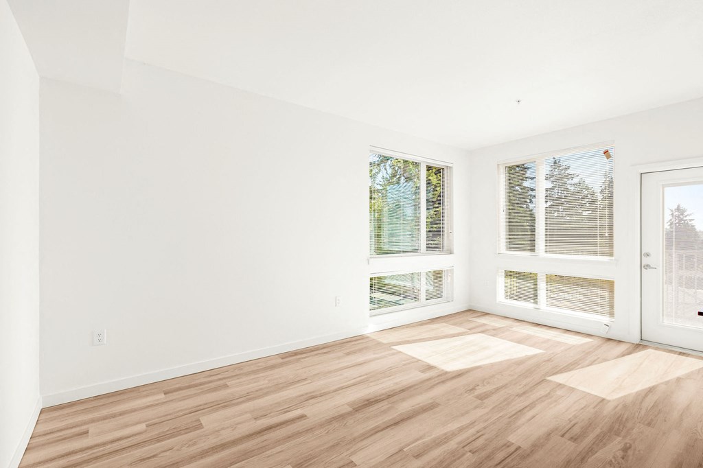 a living room with a hard wood floor and two windows at The Duo, University Place