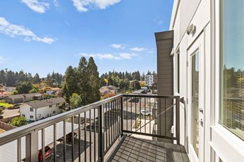 the view from the balcony of a home with a balcony railing at The Duo, University Place, 98466