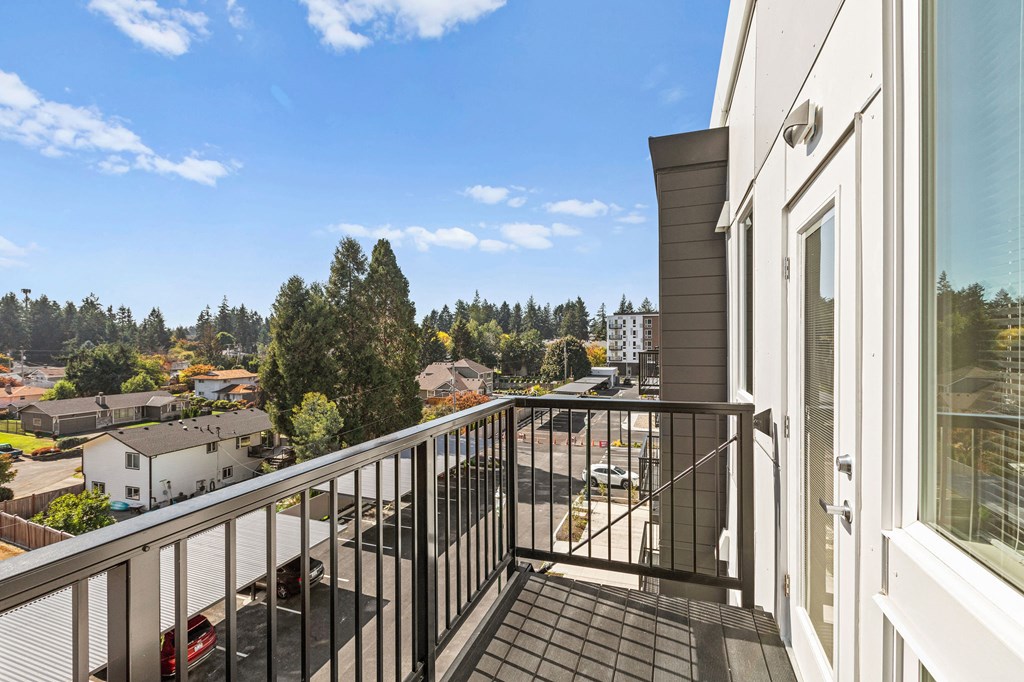 the view from the balcony of a home with a balcony railing at The Duo, University Place, WA 98466