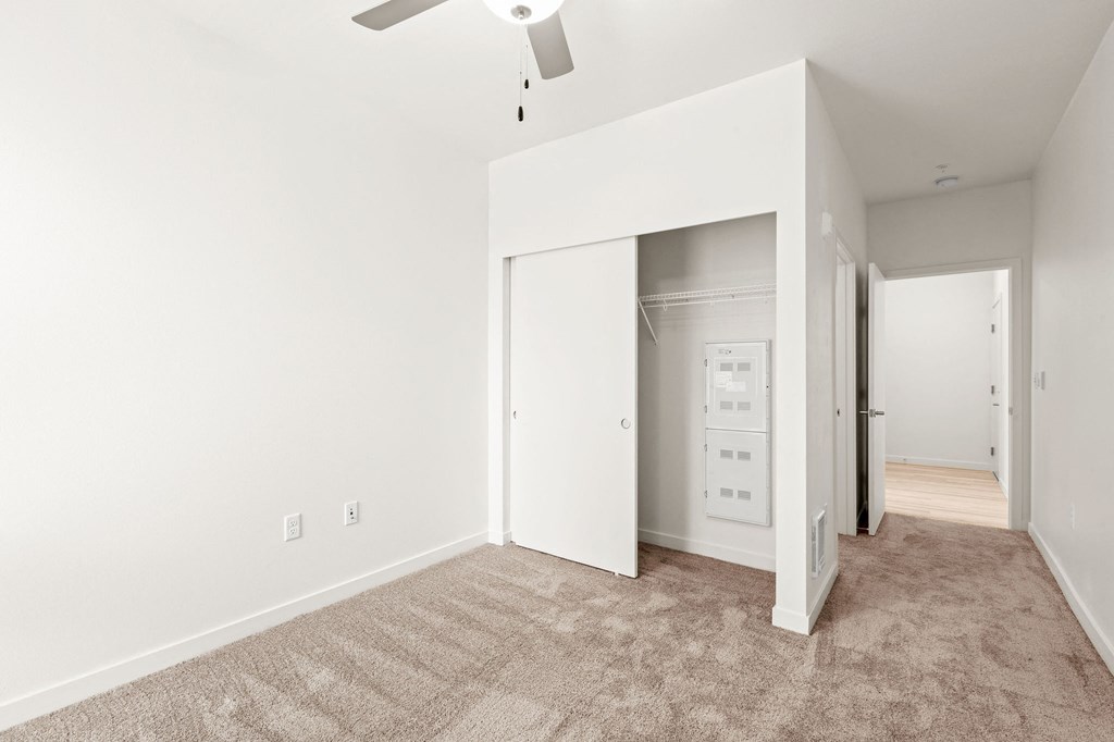 an empty living room with white walls and a ceiling fan at The Duo, Washington, 98466