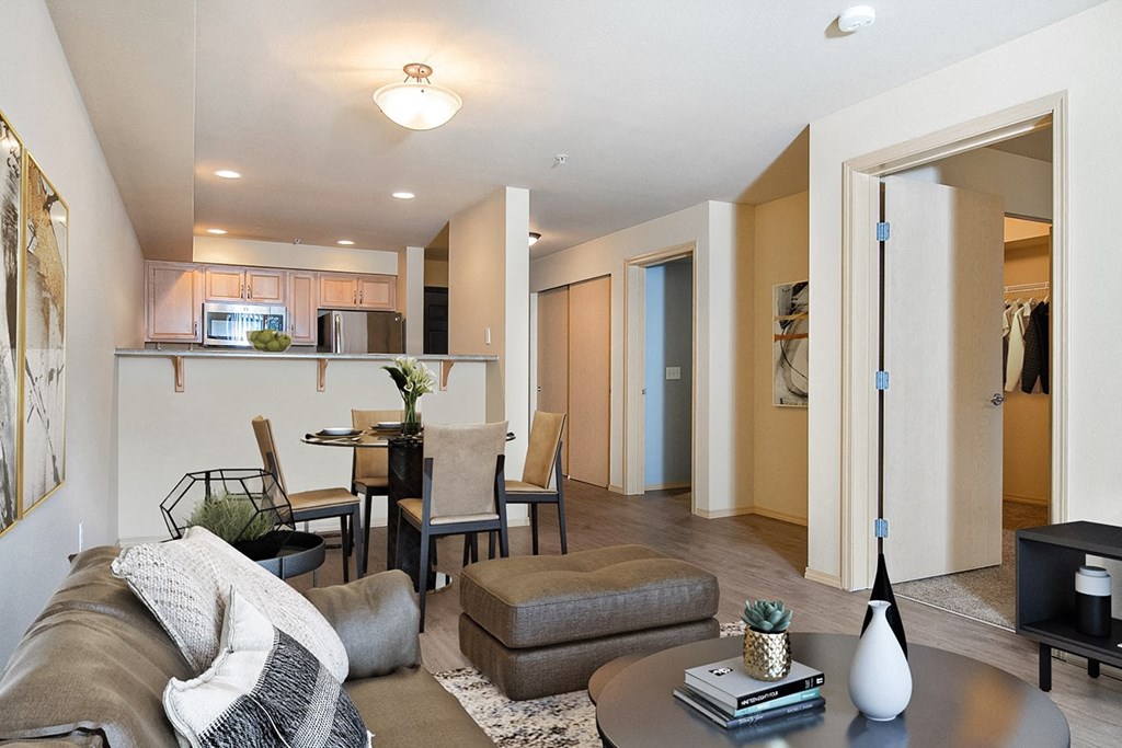 Living room looking towards the dining table and kitchen, bedroom doors on the right with a couch and coffee table on the left at 6 Wood Flats, Washington