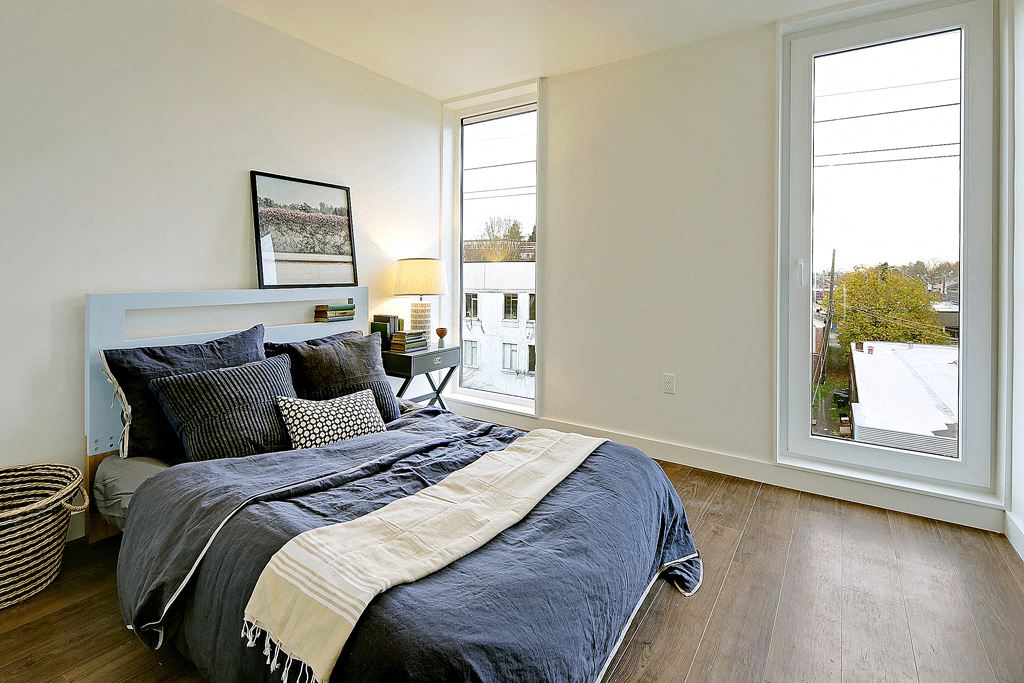 Large bedroom with 2 floor to ceiling windows. Bedroom can fit a queen or king sized bed.at 19th & Mercer, Seattle