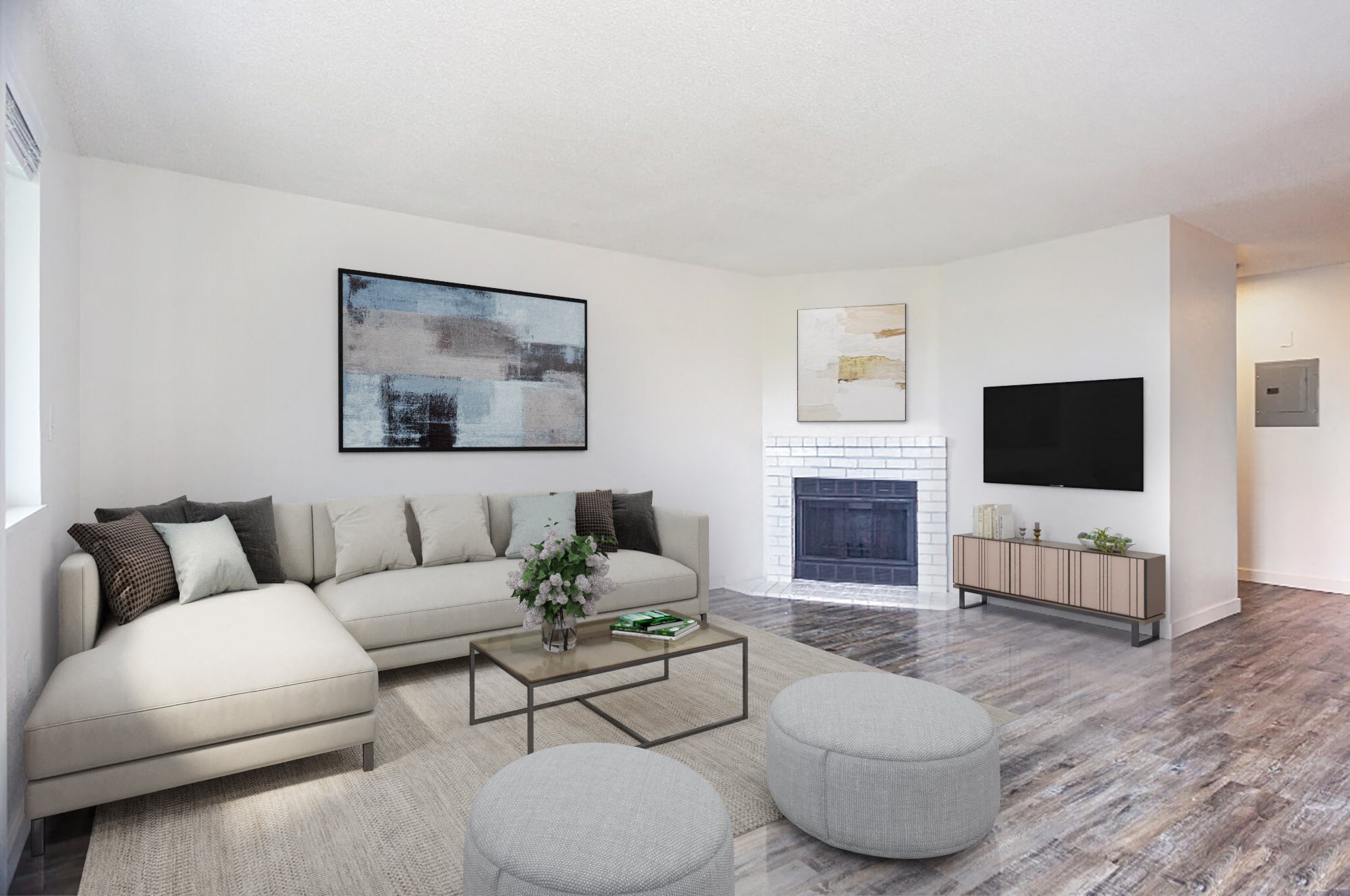 Large bright living area with faux wood flooring, fireplace on opposite wall and window to the left of the image.