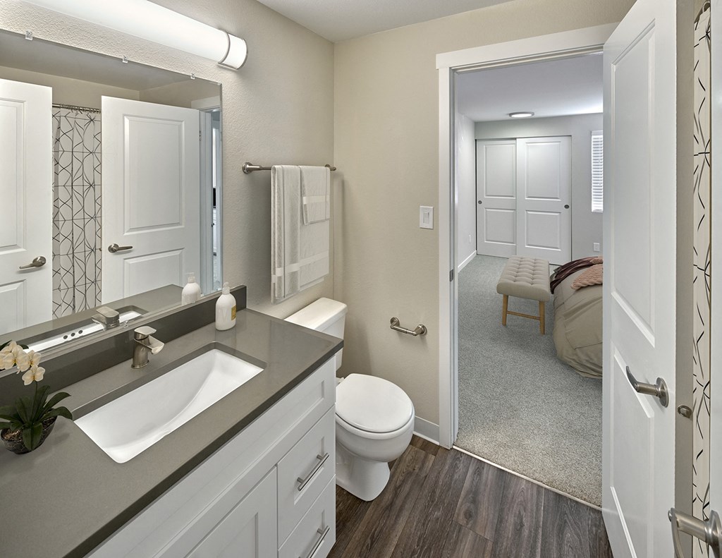 Ensuite bathroom with hard wood style flooring, toilet and vanity sinkat Edmonds Gateway, Bremerton.