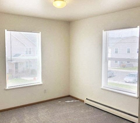 A room with a window and a view of a residential area.