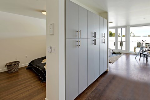 Build-in hallway storage with bedroom and living room visible in the distanceat 19th & Mercer, Seattle Washington