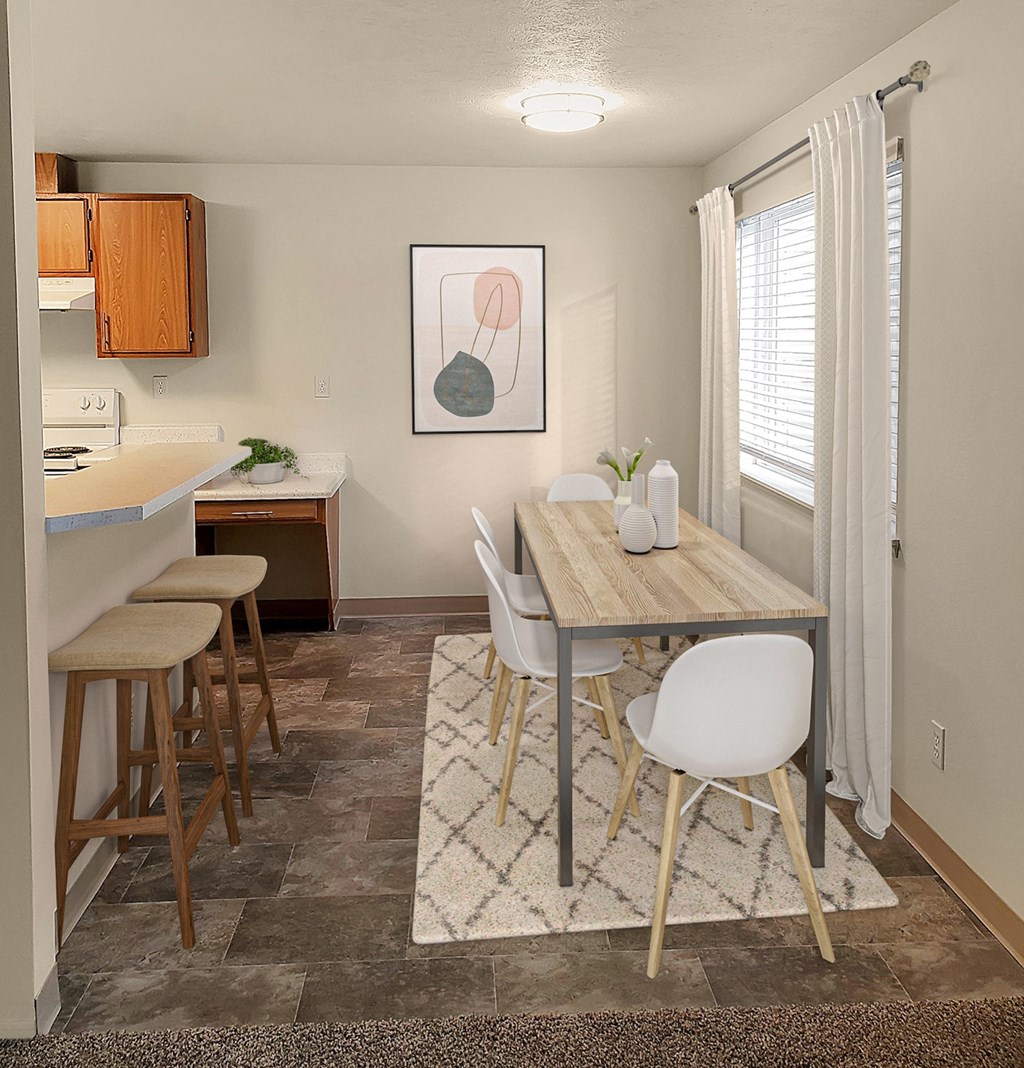 Dining area with large window, dining table, and chairs.at Clearwater, Post Falls, ID