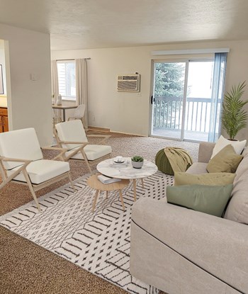 Carpeted living room with sliding glass doors to oversized patio. - Photo Gallery 8
