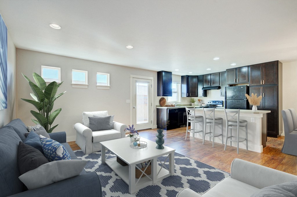 a living room with couches and a coffee table in front of a kitchen at Copper Pines, Bozeman, MT, 59718