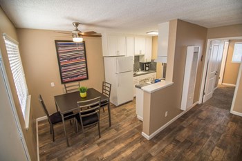 Woodland Village Dining Area Dining Area with large window and staged dining set flowing into galley style kitchen. - Photo Gallery 3