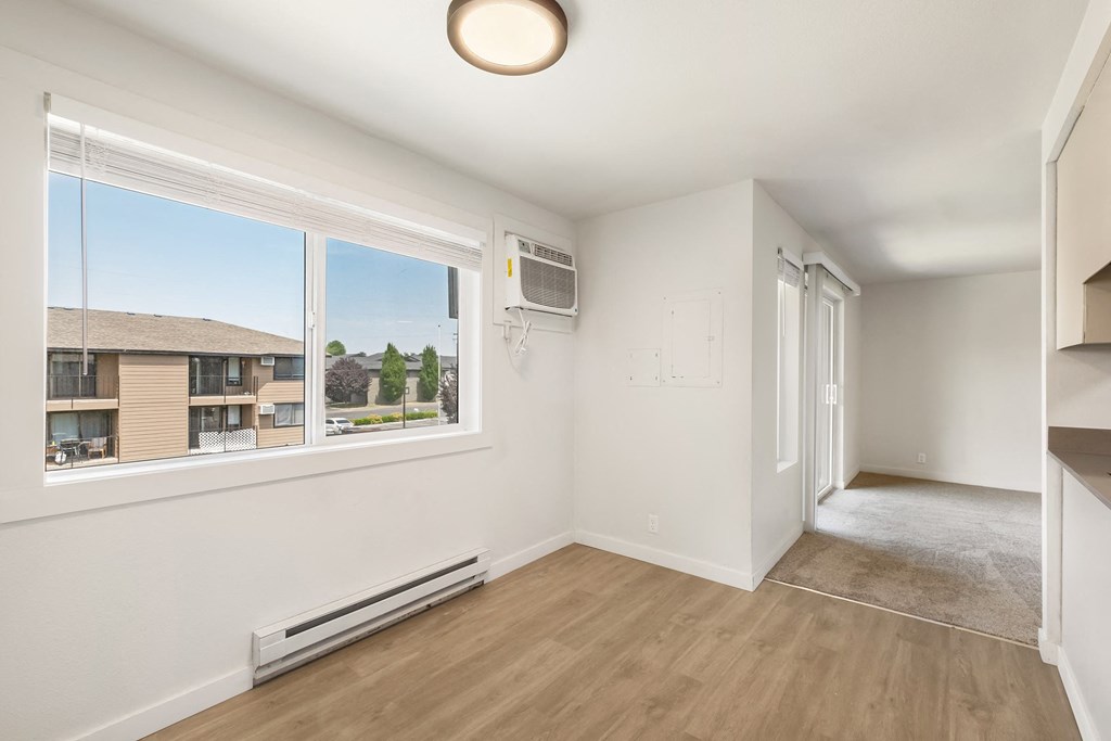 a dining room with a large window and hardwood floors  at Brix, Walla Walla