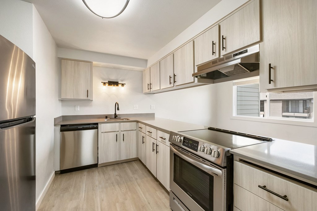 a kitchen with white cabinets and stainless steel appliances  at Brix, Washington