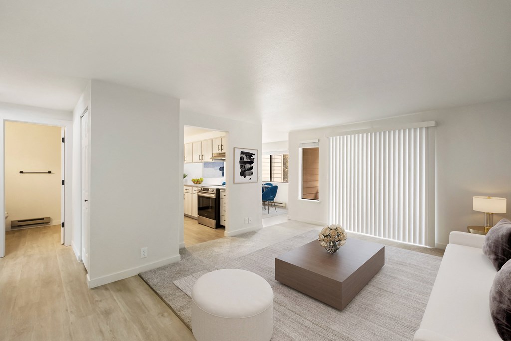 a spacious living room with white walls and hardwood floors  at Brix, Washington