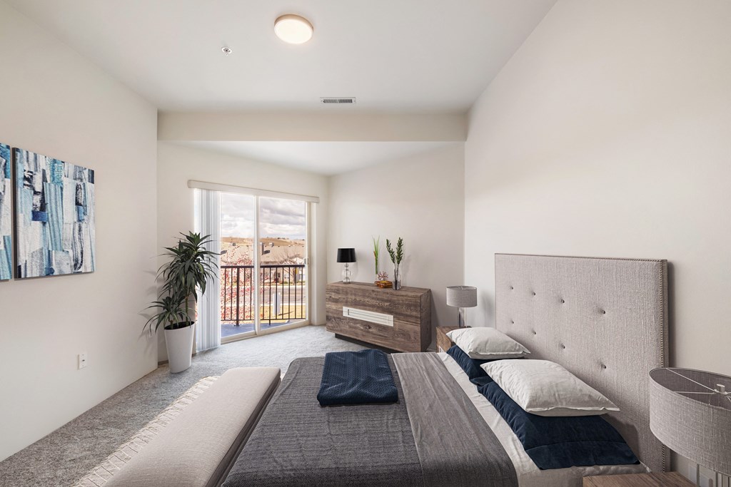 a bedroom with a queen-size bed and access to the private balcony.at Shoreline Village, Richland, WA
