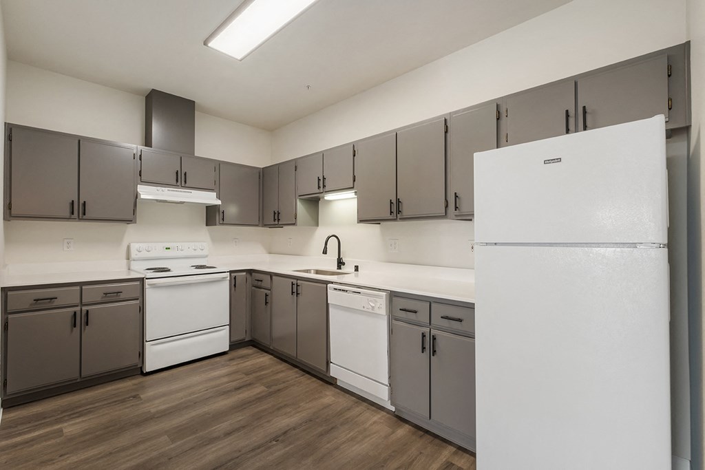 a kitchen with white appliances and gray cabinets at Shoreline Village, Washington, 99352